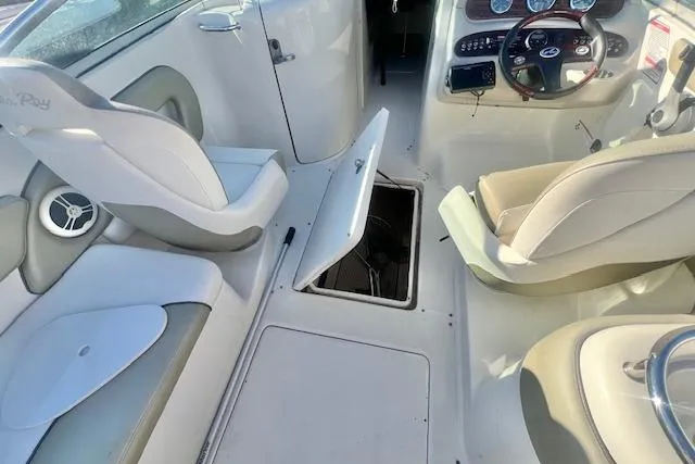 Slide: The Image of 2007 Sea Ray 240 Sundeck interior with open storage compartment and seating. - 12