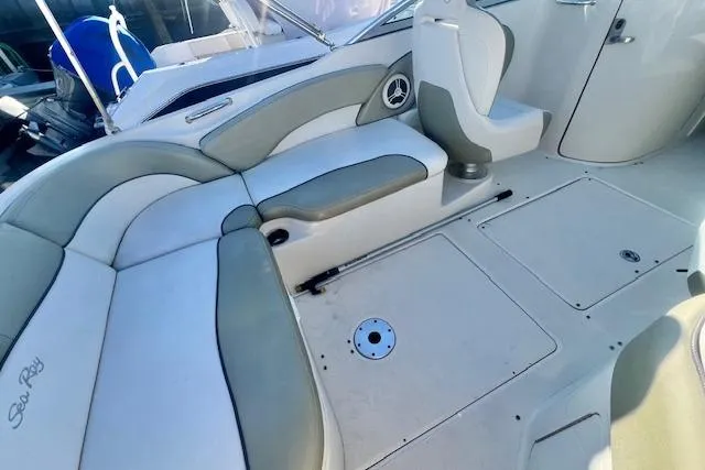 Slide: The Image of Interior of a 2007 Sea Ray 240 Sundeck boat with cushioned seating. - 14