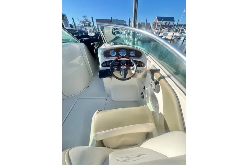 Slide: The Image of 2007 Sea Ray 240 Sundeck boat interior with steering wheel and dashboard. - 2