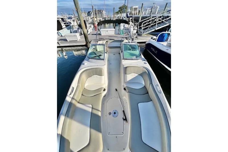 Slide: The Image of 2007 Sea Ray 240 Sundeck boat docked at marina, featuring spacious seating. - 6