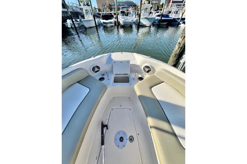 Slide: The Image of 2007 Sea Ray 240 Sundeck boat interior with seating and storage, docked at marina. - 7