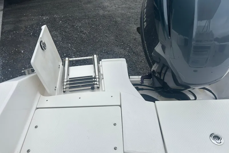 Slide: The Image of 2023 Robalo R180 Center Console boat storage compartment with ropes and fenders. - 16