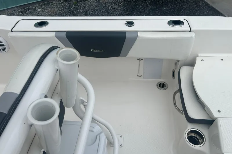 Slide: The Image of 2023 Robalo R180 Center Console boat interior with cushioned seating and cup holders. - 17