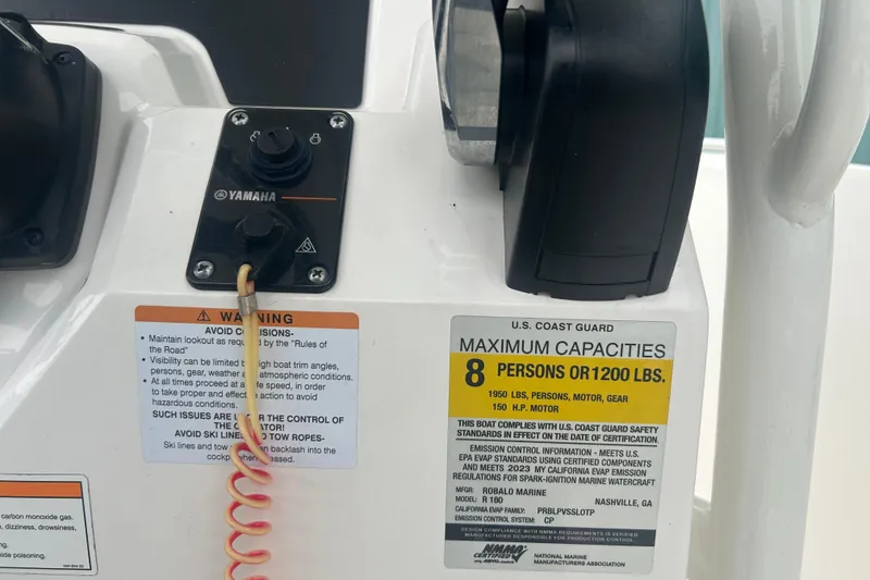 Slide: The Image of 2023 Robalo R180 Center Console anchor storage compartment open on deck. - 21