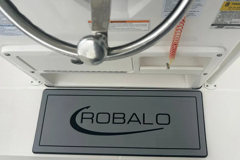 Slide: The Image of 2023 Robalo R180 Center Console boat on trailer, close-up view. - 24