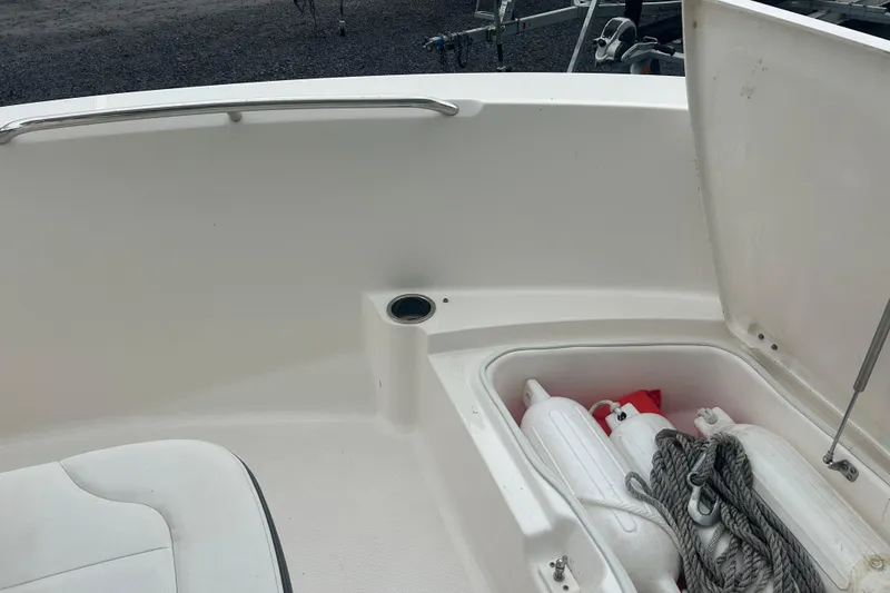 Slide: The Image of 2023 Robalo R180 Center Console boat interior with seating and storage. - 30