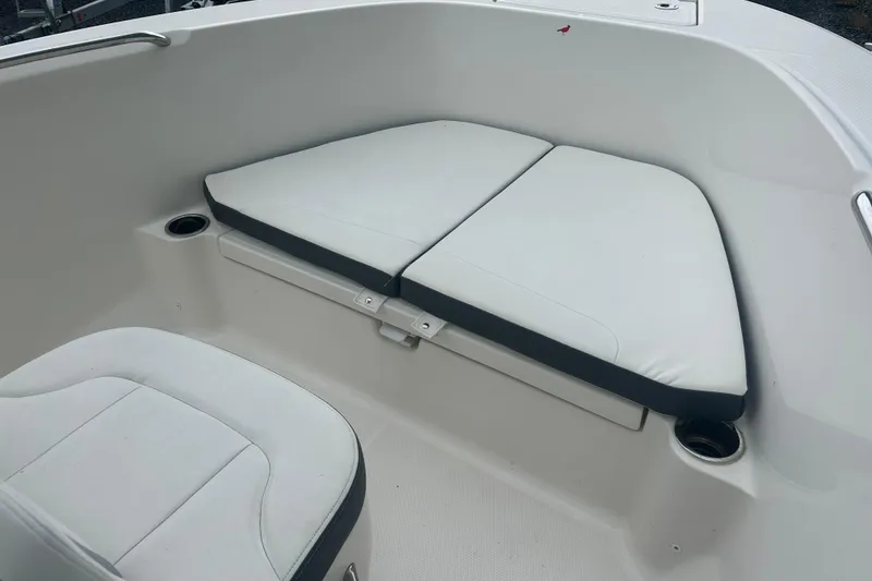 Slide: The Image of 2023 Robalo R180 Center Console boat interior in showroom setting. - 31