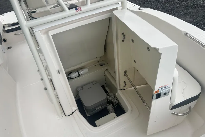 Slide: The Image of 2023 Robalo R180 Center Console boat interior in a garage setting. - 32