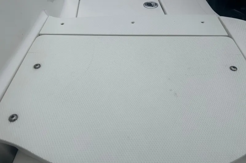 Slide: The Image of 2023 Robalo R180 Center Console boat on trailer near large warehouse. - 38