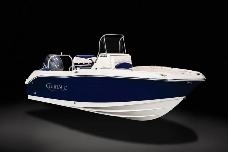 Slide: The Image of 2023 Robalo R180 Center Console boat with Yamaha engine in a garage setting. - 4