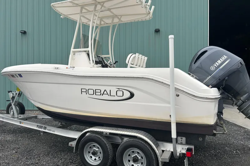 Slide: The Image of 2023 Robalo R180 Center Console boat storage compartment with open lid and visible interior. - 44