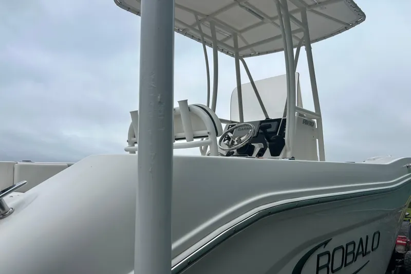 Slide: The Image of 2023 Robalo R180 Center Console boat seating area with cushioned seats and cup holders. - 45