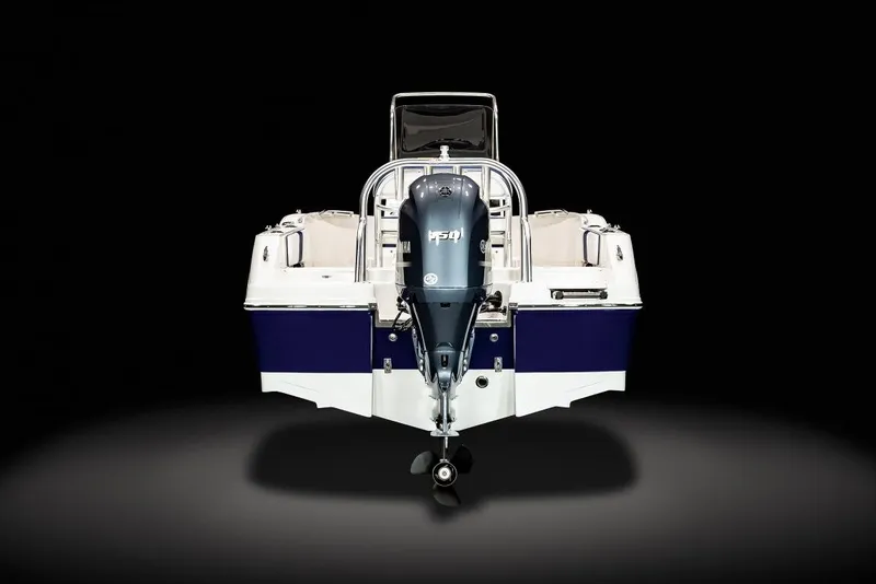 Slide: The Image of 2023 Robalo R180 Center Console boat detail with warning label and chrome rail. - 6