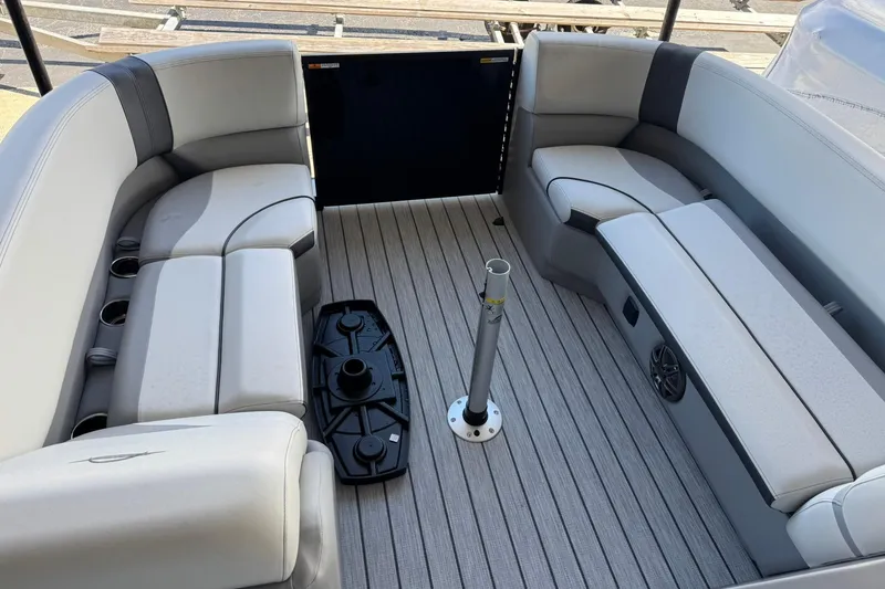 Slide: The Image of 2025 SunCatcher Select 320 RC boat interior with gray seating and cup holders. - 1