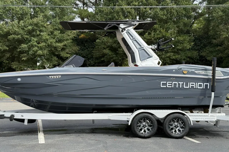 Slide: The Image of 2026 Centurion Nv233 boat on trailer, sleek design, parked outdoors. - 15