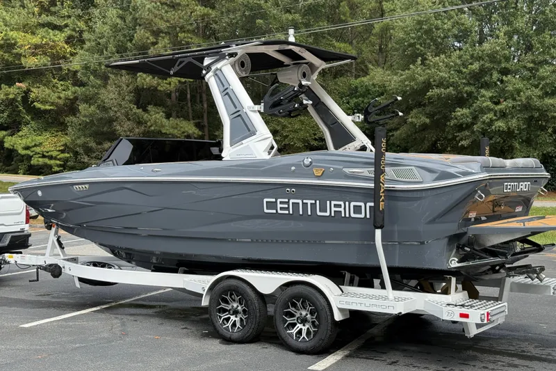 Slide: The Image of 2026 Centurion Nv233 boat on trailer, sleek gray design, parked outdoors. - 16