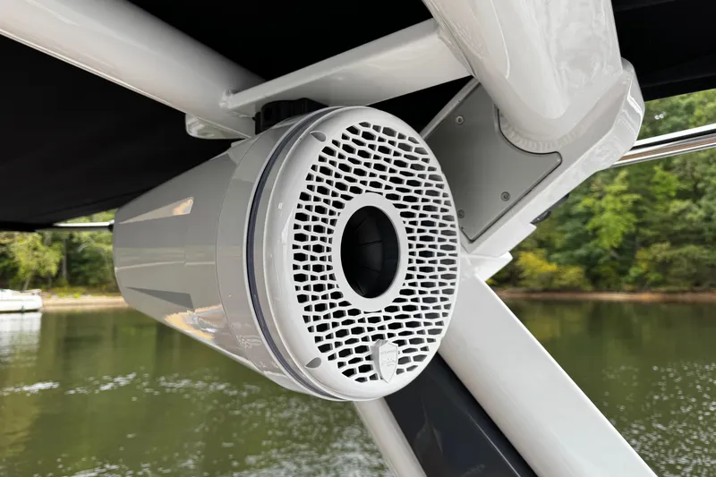 Slide: The Image of 2026 Centurion Nv233 boat speaker mounted on a sleek white frame by the water. - 18