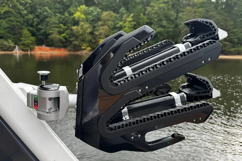 Slide: The Image of Centurion Nv233 2026 boat accessory on a lake with forested background. - 19