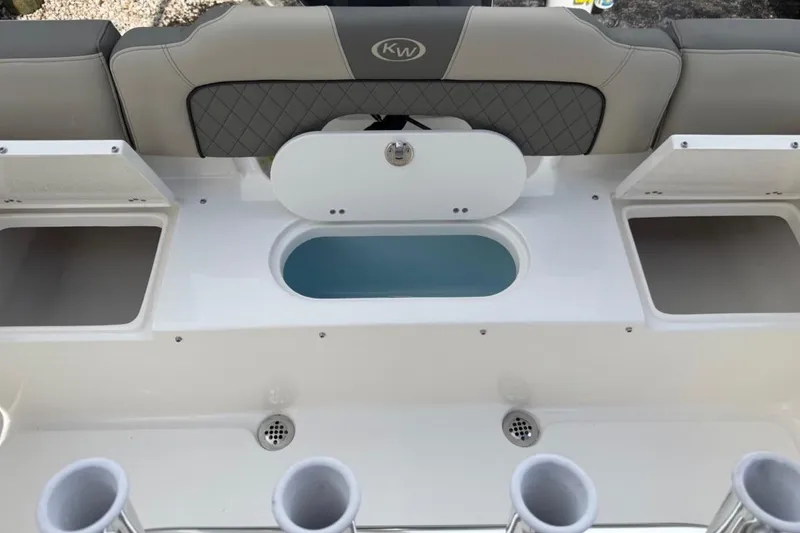 Slide: The Image of 2026 Key West 203 FS boat interior with storage compartments and rod holders. - 10