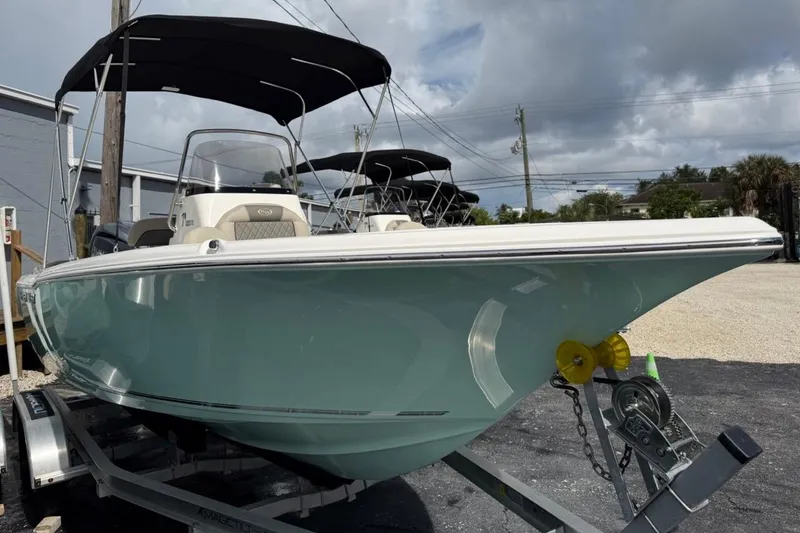 Slide: The Image of 2026 Key West 203 FS boat with canopy on trailer, parked outdoors. - 3