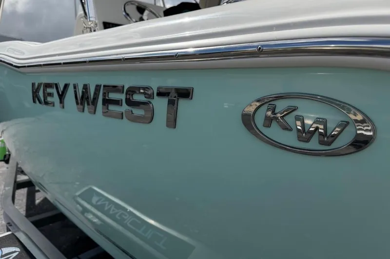 Slide: The Image of 2026 Key West 203 FS boat with KW logo on light blue hull. - 33