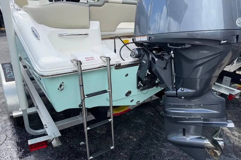 Slide: The Image of 2026 Key West 203 FS boat with outboard motor and trailer, rear view. - 6