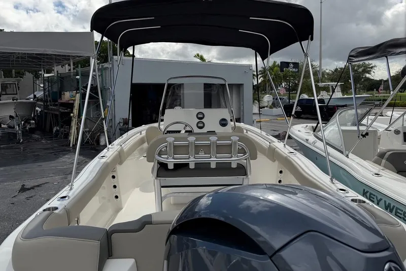 Slide: The Image of 2026 Key West 203 FS boat with canopy, parked outdoors, showcasing interior and engine. - 7