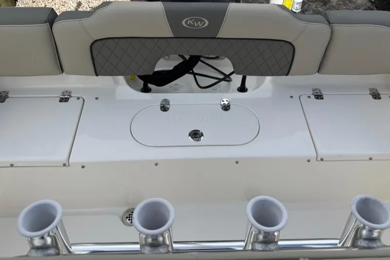 Slide: The Image of 2026 Key West 203 FS boat interior with rod holders and cushioned seating. - 9