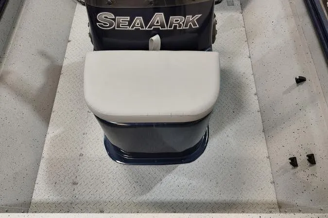 Slide: The Image of 2024 SeaArk Shadow 18 t boat interior with cushioned seat and textured flooring. - 11