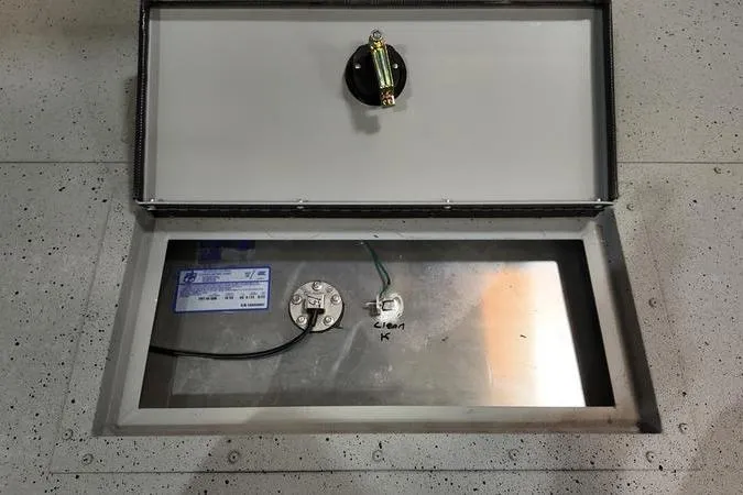 Slide: The Image of 2024 SeaArk Shadow 18 t boat compartment with wiring and components visible. - 14