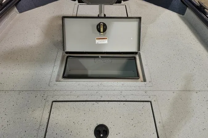 Slide: The Image of 2024 SeaArk Shadow 18 t boat interior with open storage compartment. - 15