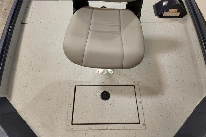 Slide: The Image of 2024 SeaArk Shadow 18 t boat interior with gray seat and storage compartment. - 19