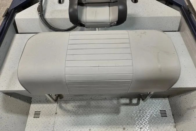 Slide: The Image of 2024 SeaArk Shadow 18 t boat interior with cushioned seating and textured flooring. - 6