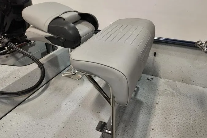 Slide: The Image of 2024 SeaArk Shadow 18 t boat interior with gray seating and textured flooring. - 7