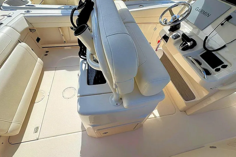 Slide: The Image of 2021 Grady-White Canyon 271 boat interior with helm, seating, and Garmin navigation system. - 11