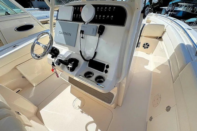 Slide: The Image of 2021 Grady-White Canyon 271 boat interior with Garmin navigation system and steering console. - 12