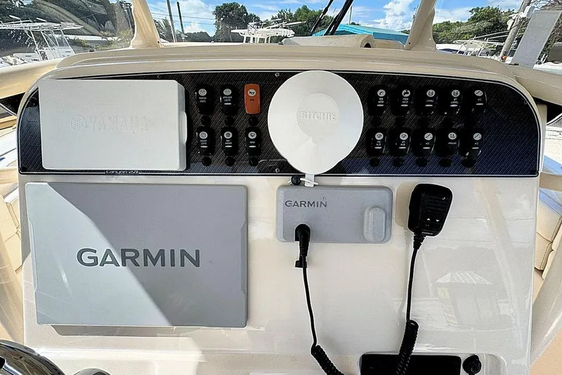 Slide: The Image of 2021 Grady-White Canyon 271 dashboard with Garmin navigation and control panel. - 13