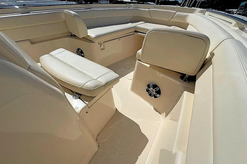 Slide: The Image of 2021 Grady-White Canyon 271 boat interior with beige seating and speaker. - 17