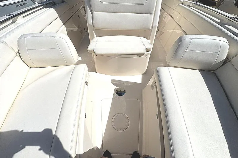 Slide: The Image of 2021 Grady-White Canyon 271 boat interior with white cushioned seating. - 18