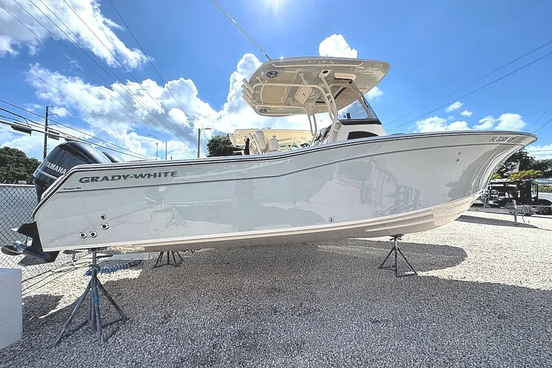 Slide: The Image of 2021 Grady-White Canyon 271 boat displayed outdoors under a bright blue sky. - 3
