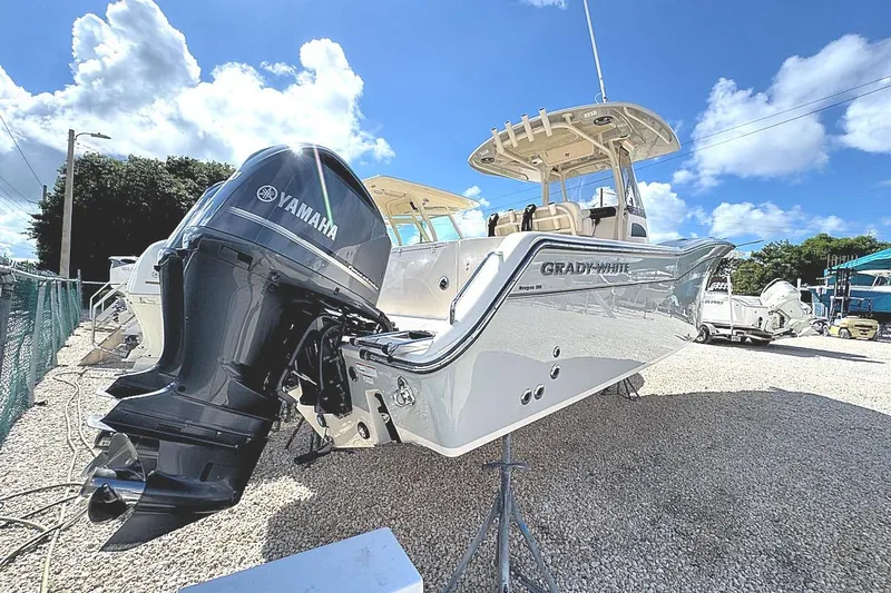 Slide: The Image of 2021 Grady-White Canyon 271 boat with Yamaha engine under clear blue sky. - 4
