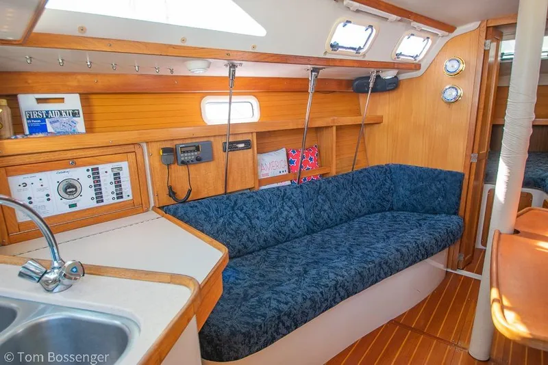 Slide: The Image of Interior of 1997 Catalina 320 MkII sailboat with blue seating and wooden accents. - 14