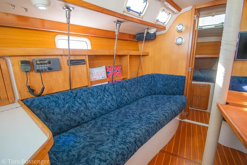 Slide: The Image of Interior of 1997 Catalina 320 MkII sailboat with blue seating and wooden accents. - 16