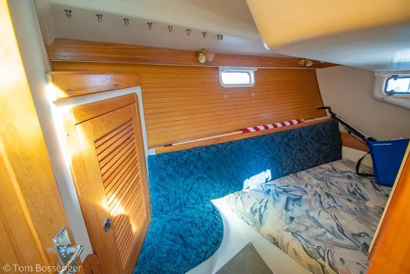 Slide: The Image of Interior cabin of a 1997 Catalina 320 MkII sailboat with wooden accents and seating. - 23