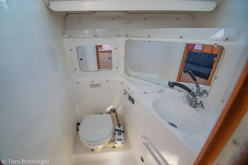 Slide: The Image of Bathroom interior of a 1997 Catalina 320 MkII yacht, featuring a toilet and sink. - 25