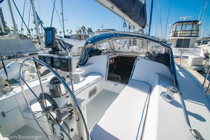 Slide: The Image of 1997 Catalina 320 MkII sailboat cockpit with steering wheel and navigation equipment. - 27