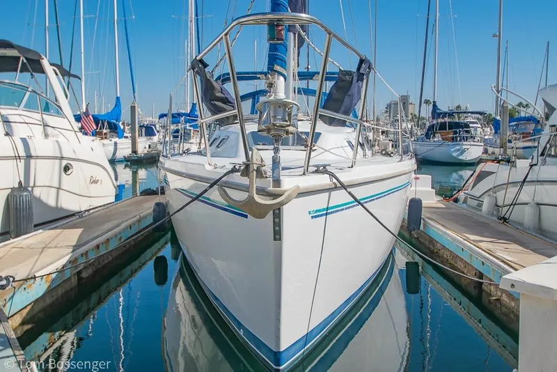 Slide: The Image of 1997 Catalina 320 MkII sailboat docked in a marina, surrounded by other boats. - 3