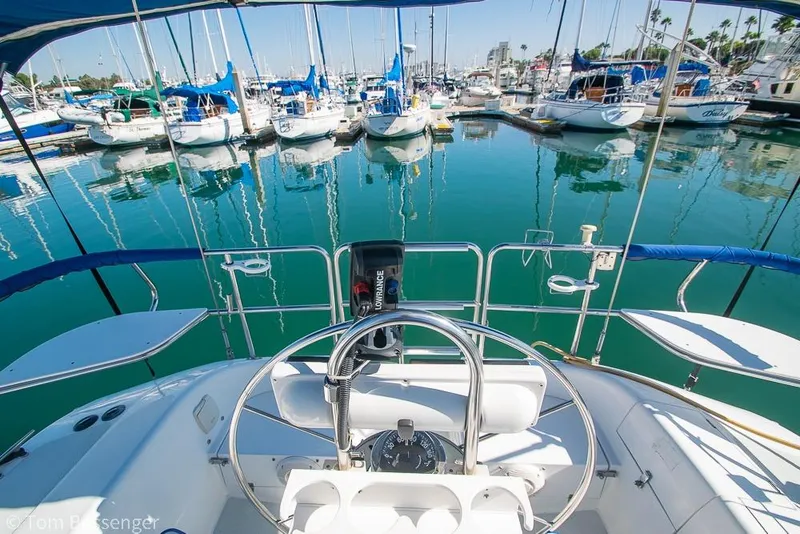 Slide: The Image of Cockpit view of a 1997 Catalina 320 MkII sailboat docked in a marina. - 32