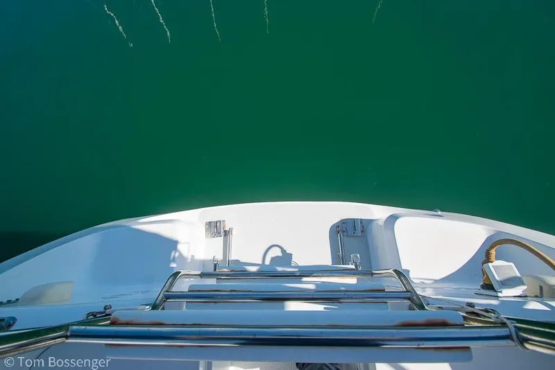 Slide: The Image of Catalina 320 MkII sailboat stern view, 1997 model, over calm green water. - 33