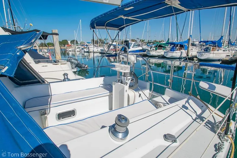 Slide: The Image of 1997 Catalina 320 MkII sailboat in marina, featuring blue canopy and polished deck. - 5